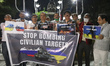 Peoples take part in a candle light vigil for peace as they Protest against Russia's invas...