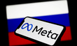 Meta logo displayed on a phone screen and Russian flag displayed on a screen in the backgr...