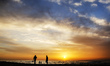 Palestinians enjoy and walk in front of Gaza beach during sunset, on March 02, 2022. 