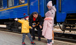People evacuated from Ukrainian cities under fire from the Russian army are seen by the tr...