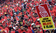 Pro-government ethnic Malay hardliners wave flags and shout slogans during a demonstration...