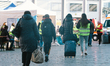 two volunteers helps a family refugees  in front of cologne central station in Cologne, Ge...