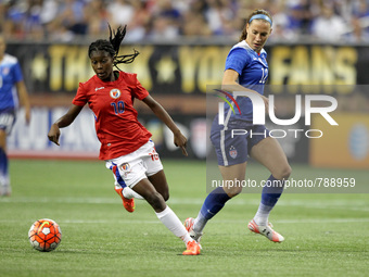 Haiti's forward Betcheba Louis carries the ball against US midfielder Lauren Holiday during the second half of the International Friendly ma...