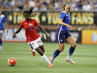 Haiti's forward Betcheba Louis carries the ball against US midfielder Lauren Holiday during the second half of the International Friendly ma...