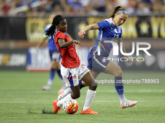 Haiti's forward Betcheba Louis (10) carries the ball against US midfielder Lauren Holiday (12) during the second half of the International F...
