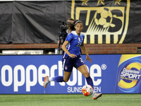 US forward Christen Press carries the ball up there field during the first half of the International Friendly match between the United State...