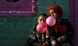 Misba And Sobia fills air in the balloon as they sit at their residence in a far flung Are...