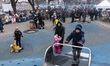 Children spend time on the playground outside the main railway station in Lviv, western Uk...