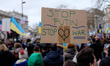 A protester holds up a home-made placard during the protest outisde Downing street in Lond...