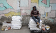 A Palestinian collects food aid at a distribution center run by the United Nations Relief...