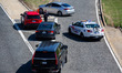 An officer allows a vehicle to pass as police block entrance ramps and monitor traffic in...