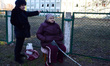 Two senior women stay in front of a fence after a residential in Sviatoshynskyi district s...