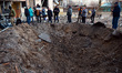 The crater of a shell is pictured in a residential area in Sviatoshynskyi district after s...