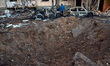 The crater from a shell is pictured in a residential area in Sviatoshynskyi district after...