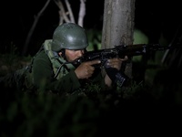 Indian army soldiers take position during Night CASO Cordon And Search Operation drill in South Kashmir's Kulgam District, Jammu and Kashmir...