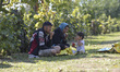 A family of migrants taking a break after crossing the between Serbia and Croatia in Babsk...