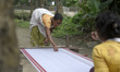 An Assamese woman weaves Assamese Traditional Gamosa (scarf) in handloom, ahead of Rongali...