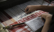 An Assamese woman weaves Assamese Traditional Gamosa (scarf) in handloom, ahead of Rongali...