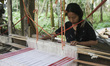 An Assamese woman weaves Assamese Traditional Gamosa (scarf) in handloom, ahead of Rongali...