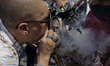 A person throws tobacco smoke at a figure of Santa Muerte outside her temple in Tepito, Me...