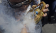 A person throws tobacco smoke at a figure of Santa Muerte outside her temple in Tepito, Me...