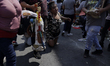 A woman kneels outside the Santa Muerte temple in Tepito, Mexico City, where several paris...