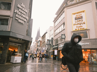 a shopper walks with face mask in the city center of Cologne, Germany on April 4, 2022 after Germany lifts majority of covid 19 restrictions...