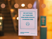 "we recommend to wear face mask in our store" sign is seen in front of Primark, the clothing restailer in the city center of Cologne, German...