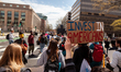 Protesters march around teh Department of Education during a rally to cancel student debt....