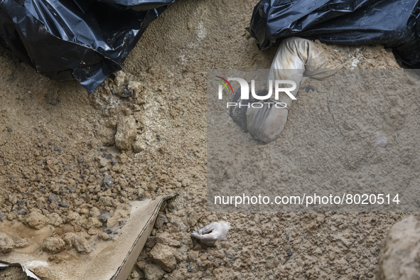 (EDITORS NOTE: Image depicts graphic content)Bodies of civil locals in plastic bags lay in a mass grave in the recaptured by the Ukrainian a...