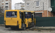 Destroyed civil vehicle  near a damaged residential building in the recaptured by the Ukra...