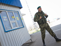 Ukrainian border guard with a gun patroling at the BCP Customs Control Zone on the border between Ukraine and Moldova (