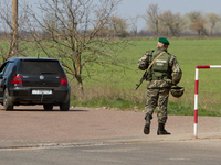 Ukrainian border guards check vehicles at the BCP on the border between Ukraine and Moldova before they enter Customs Control Zone (