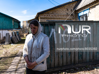 BUCHA, UKRAINE - APRIL 7, 2022 - Local resident Tetiana stays outside her house after the liberation of the city from Russian invaders, Buch...