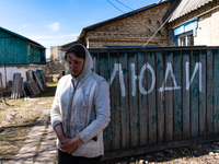 BUCHA, UKRAINE - APRIL 7, 2022 - Local resident Tetiana stays outside her house after the liberation of the city from Russian invaders, Buch...