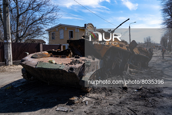BUCHA, UKRAINE - APRIL 7, 2022 - Destroyed military vehicles are seen near a fence marked with the word 'People' after the liberation of the... by Anna Voitenko/Ukrinform/NurPhoto