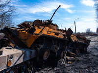 BUCHA, UKRAINE - APRIL 7, 2022 - Destroyed military vehicles are seen near a fence marked with the word 'People' after the liberation of the...