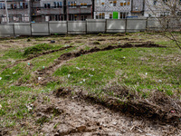 BUCHA, UKRAINE - APRIL 7, 2022 - The tracks left by a military vehicle are visible in the turf after the liberation of the city from Russian...