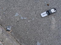 BUCHA, UKRAINE - APRIL 7, 2022 - A broken mobile phone lies on the ground as seen after the liberation of the city from Russian invaders, Bu...