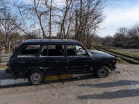 BUCHA, UKRAINE - APRIL 7, 2022 - A damaged car is seen on a street after the liberation of the city from Russian invaders, Bucha, Kyiv Regio...