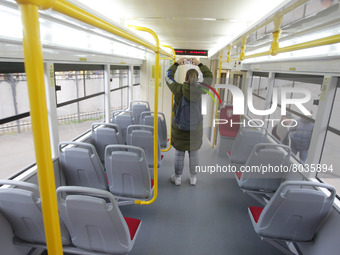 An journalist takes a photo during a presentation of the new multi-section Odissey MAX tram, maded in the car repair workshops of the city c...