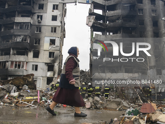 The woman goes past Residential building Destroyed by Russian army in Borodyanka city near Kyiv, Ukraine, 09 April 2022 (
