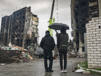 Local residents observed as Ukrainian Rescuers worked to clear the rubble after the collapse of buildings destroyed by russian army in Borod...