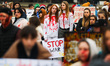 Ukrainian citizens and supporters attend a silent protest at the Main Square against the m...