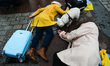 Ukrainian citizens and supporters lay on the ground playing dead while attending a silent...