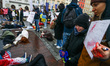 Ukrainian citizens and supporters lay on the ground playing dead while attending a silent...