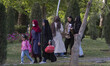 Iranian women stand together in an urban park in downtown Tehran on April 11, 2022. Follow...