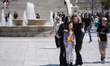 Tourists and locals are enjoy the warm weather at Syntagma square in the center of Athens,...