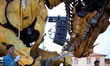 An operator stands guard near Long-Ma. A robot, a mare-dragon called Long-Ma, created by F...