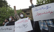 A group of Iranian men shout slogans to condemn Koran Burning in the Sweden, while holding...